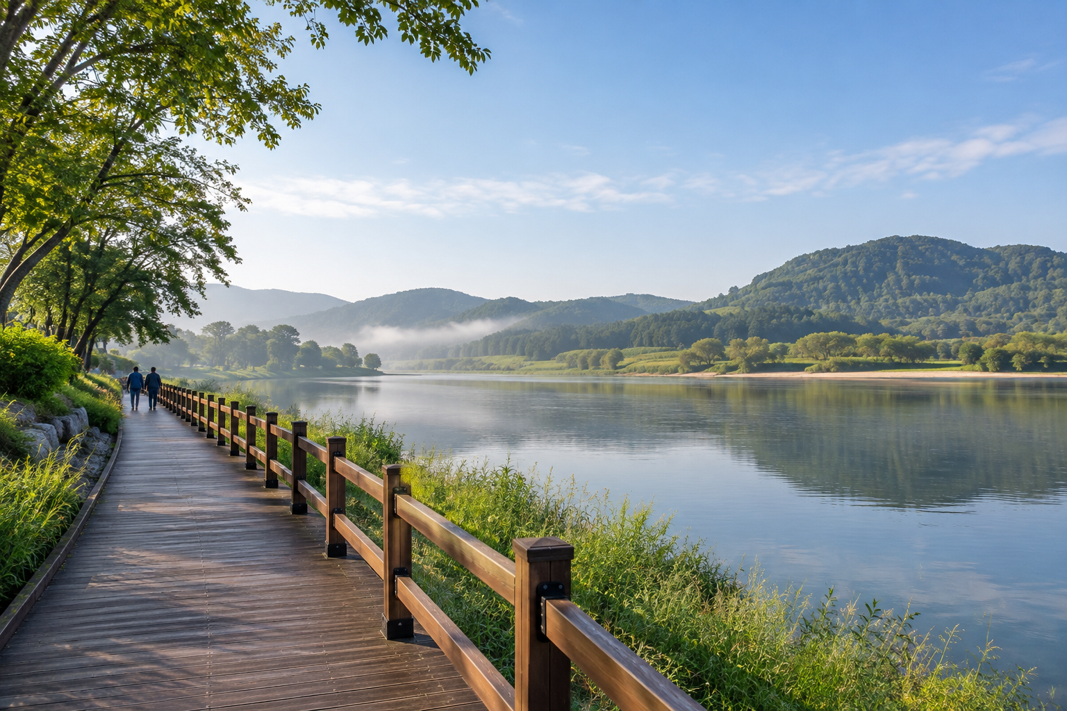 Generic public riverside walking path with calm water and distant hills; no hotel identity.